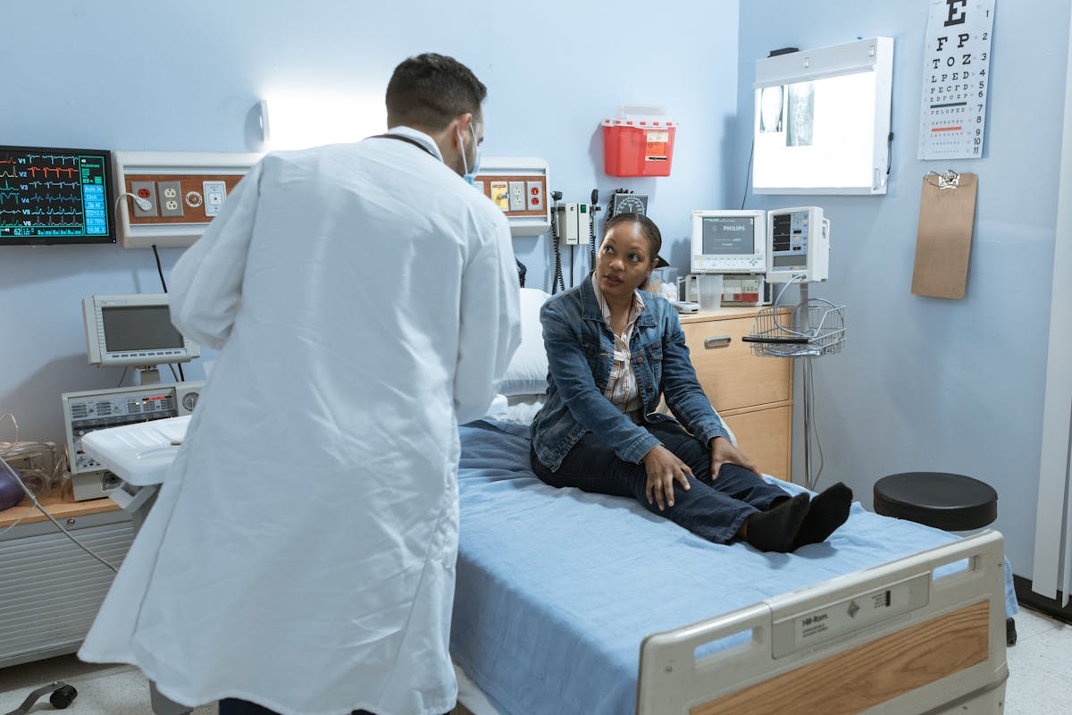 Doctor consulting with a patient in a hospital room about their medical treatment options