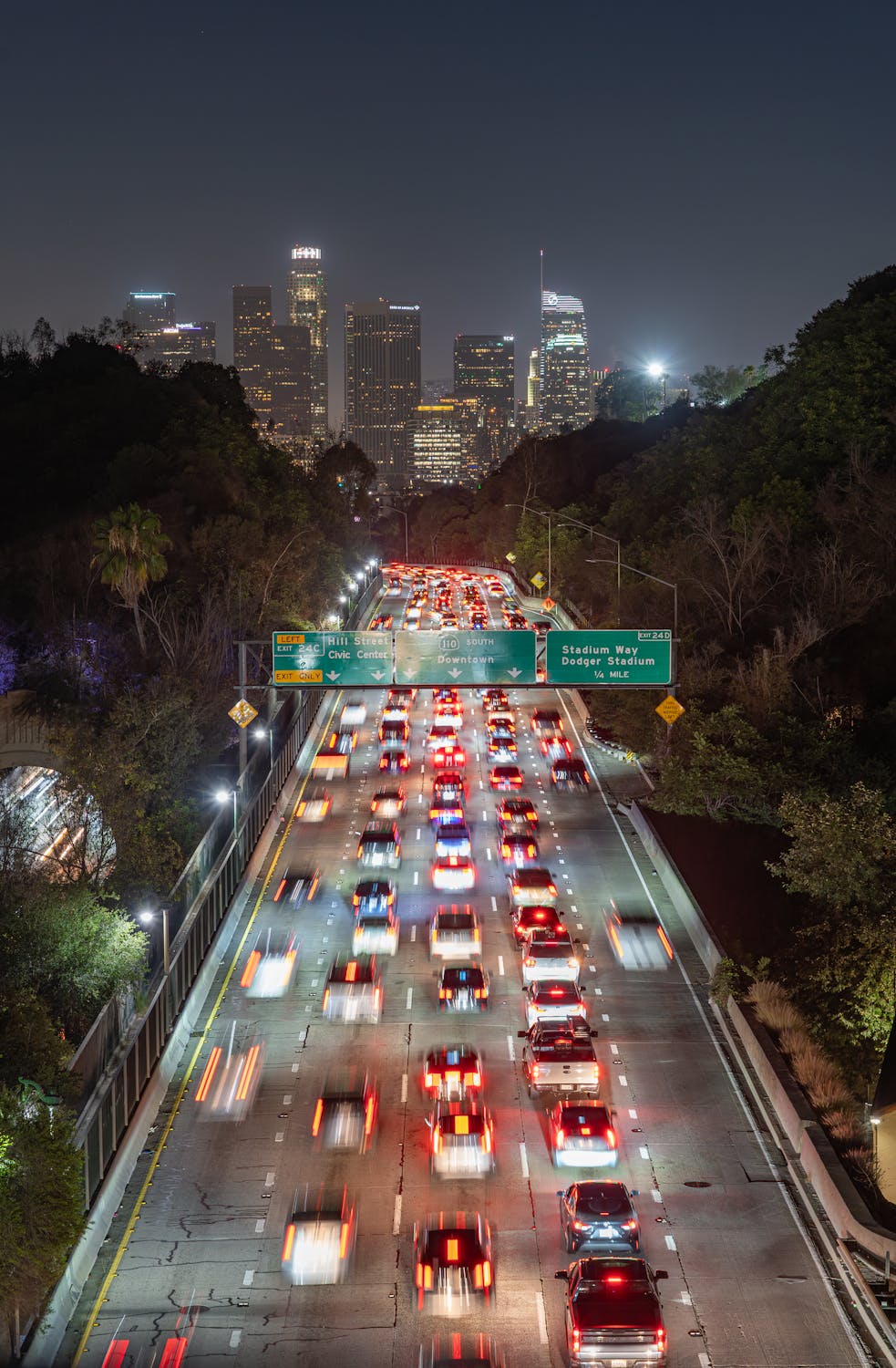 Los Angeles freeway traffic at night with downtown skyline view