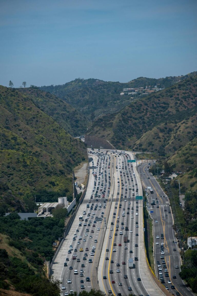 Multi-lane highway with heavy traffic surrounded by hills near Riverside California