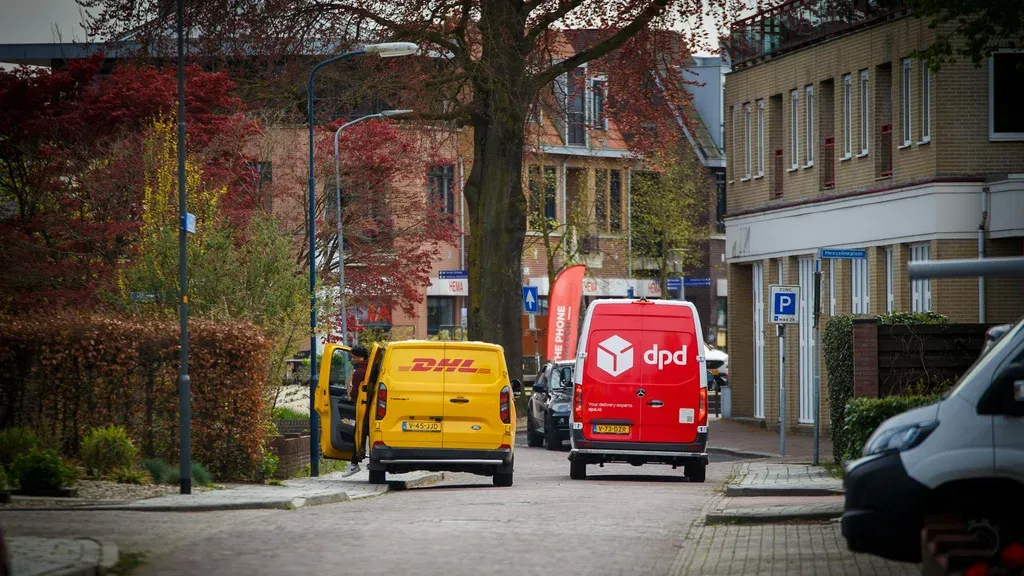 Delivery vans parked on a residential street representing the rise of delivery vehicle traffic in California