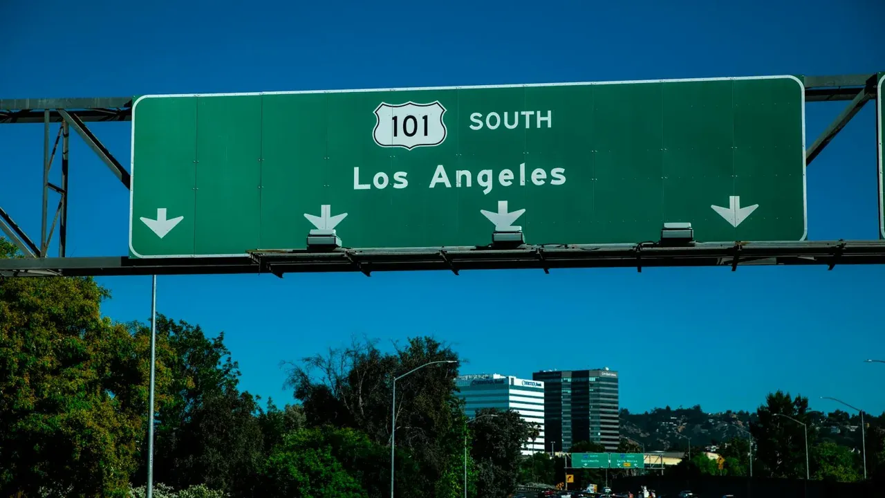 Highway 101 traffic in Los Angeles near signs for downtown and Santa Monica